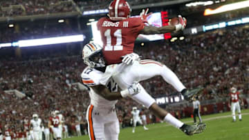 Auburn football defensive back Roger McCreary (17) hits Alabama wide receiver Henry Ruggs III (11) before the ball arrives as Ruggs hauls in a touchdown pass in Bryant-Denny Stadium during Alabama's 52-21 victory over Auburn in the Iron Bowl Saturday, Nov. 24, 2018. [Staff Photo/Gary Cosby Jr.]