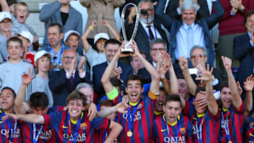 Captain Roger Riera of FC Barcelona (C) holds the Lennart Johansson trophy after winning the UEFA Youth League Final match between Benfica Lisbon and FC Barcelona at Colovray Stadion on April 14, 2014. (Photo by Philipp Schmidli/Getty Images)