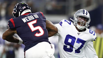 ARLINGTON, TEXAS - AUGUST 24: Taco Charlton #97 of the Dallas Cowboys makes a tackle against Joe Webb #5 of the Houston Texans in the first quarter during a NFL preseason game at AT&T Stadium on August 24, 2019 in Arlington, Texas. (Photo by Ronald Martinez/Getty Images)