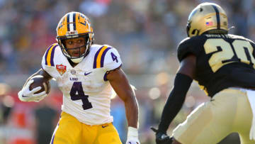 ORLANDO, FLORIDA - JANUARY 02: John Emery Jr. #4 of the LSU Tigers rushes during the Cheez-It Citrus Bowl against the Purdue Boilermakers at Camping World Stadium on January 02, 2023 in Orlando, Florida. (Photo by Mike Ehrmann/Getty Images)