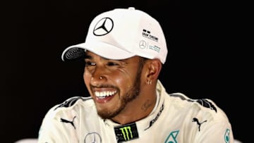 ABU DHABI, UNITED ARAB EMIRATES - NOVEMBER 26: Second place finisher Lewis Hamilton of Great Britain and Mercedes GP celebrates with his trophy on the podium during the Abu Dhabi Formula One Grand Prix at Yas Marina Circuit on November 26, 2017 in Abu Dhabi, United Arab Emirates. (Photo by Mark Thompson/Getty Images)