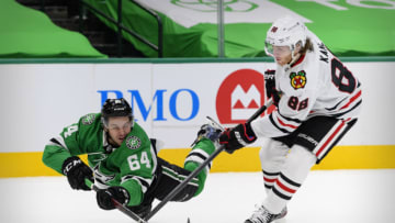 Feb 9, 2021; Dallas, Texas, USA; Dallas Stars center Tanner Kero (64) knocks the puck away from Chicago Blackhawks right wing Patrick Kane (88) during the second period at the American Airlines Center. Mandatory Credit: Jerome Miron-USA TODAY Sports