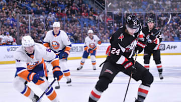 Oct 21, 2023; Buffalo, New York, USA; Buffalo Sabres center Dylan Cozens (24) controls the puck as New York Islanders defenseman Noah Dobson (8) defends in the second period at KeyBank Center. Mandatory Credit: Mark Konezny-USA TODAY Sports
