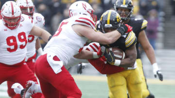 IOWA CITY, IOWA- NOVEMBER 23: Running back Mekhi Sargent #10 of the Iowa Hawkeyes is tackled during the first half by defensive lineman Ben Stille #95 of the Nebraska Cornhuskers on November 23, 2018 at Kinnick Stadium, in Iowa City, Iowa. (Photo by Matthew Holst/Getty Images)
