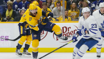 NASHVILLE, TENNESSEE - JANUARY 27: Craig Smith #15 of the Nashville Predators takes a shot past Travis Dermott #23 of the Toronto Maple Leafs during the third period of a 5-2 Leafs victory at Bridgestone Arena on January 27, 2020 in Nashville, Tennessee. (Photo by Frederick Breedon/Getty Images)