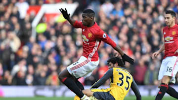 Arsenal's Egyptian midfielder Mohamed Elneny (R) tackles Manchester United's French midfielder Paul Pogba during the English Premier League football match between Manchester United and Arsenal at Old Trafford in Manchester, north west England, on November 19, 2016. / AFP / Paul ELLIS / RESTRICTED TO EDITORIAL USE. No use with unauthorized audio, video, data, fixture lists, club/league logos or 'live' services. Online in-match use limited to 75 images, no video emulation. No use in betting, games or single club/league/player publications. / (Photo credit should read PAUL ELLIS/AFP/Getty Images)