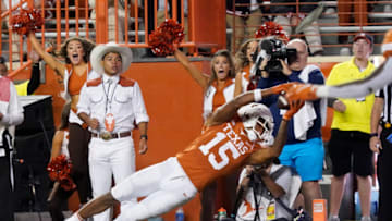 Auburn footballNov 13, 2021; Austin, Texas, USA; Texas Longhorns wide receiver Marcus Washington (15) reaches in to the end zone for the go head touchdown in overtime against the Kansas Jayhawks at Darrell K Royal-Texas Memorial Stadium. Mandatory Credit: Scott Wachter-USA TODAY Sports