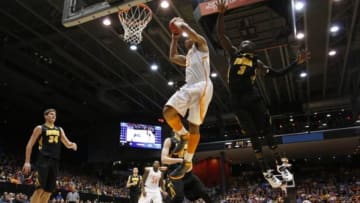 Mar 19, 2014; Dayton, OH, USA; Tennessee Volunteers forward Jarnell Stokes (5) goes up for a shot while being defended by Iowa Hawkeyes guard Peter Jok (3) in the first half of a college basketball game during the first round of the 2014 NCAA Tournament at UD Arena. Tennessee defeated Iowa in overtime 78-65. Mandatory Credit: Rick Osentoski-USA TODAY Sports