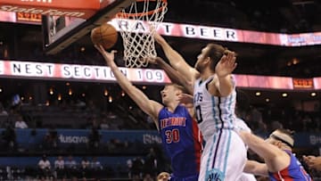 Nov 29, 2016; Charlotte, NC, USA; Detroit Pistons forward center Jon Leuer (30) drives to the basket and scores defended by Charlotte Hornets forward center Spencer Hawes (00) during the first half of the game at the Spectrum Center. Mandatory Credit: Sam Sharpe-USA TODAY Sports