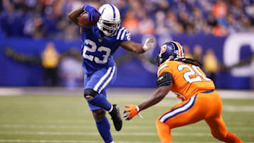 Frank Gore #23 of the Indianapolis Colts pushes off a tackle from Jamal Carter #20 of the Denver Broncos during the second half at Lucas Oil Stadium on December 14, 2017 in Indianapolis, Indiana. (Photo by Joe Robbins/Getty Images)