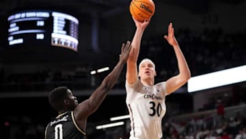 Cincinnati Bearcats forward Viktor Lakhin rises for a shot against UCF Knights at Fifth Third Arena. The Enquirer.