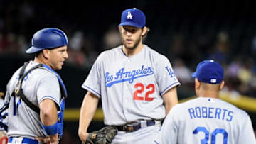 Jun 15, 2016; Phoenix, AZ, USA; Los Angeles Dodgers manager Dave Roberts (30) pulls starting pitcher Clayton Kershaw (22) from the game as catcher A.J. Ellis (17) looks on in the eighth inning against the Arizona Diamondbacks at Chase Field. Mandatory Credit: Matt Kartozian-USA TODAY Sports