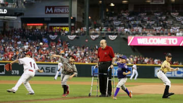 PHOENIX, AZ - MARCH 31: Former MLB player and announcer, Joe Garagiola, Sr stands with Arizona little league players as they throw out the Ceremonial first pitch before the Opening Day MLB game against the San Francisco Giants at Chase Field on March 31, 2014 in Phoenix, Arizona. (Photo by Christian Petersen/Getty Images)