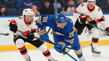 BUFFALO, NY - FEBRUARY 17: Erik Brannstrom #26 of the Ottawa Senators gets a penalty for tripping Cody Eakin #20 of the Buffalo Sabres during the first period at KeyBank Center on February 17, 2022 in Buffalo, New York. (Photo by Kevin Hoffman/Getty Images)