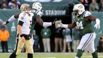 Nov 3, 2013; East Rutherford, NJ, USA; New York Jets nose tackle Damon Harrison (94) and New York Jets defensive end Muhammad Wilkerson (96) celebrate a sack of New Orleans Saints quarterback Drew Brees (9) during the second half at MetLife Stadium. The Jets won the game 26-20. Mandatory Credit: Joe Camporeale-USA TODAY Sports