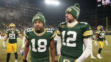 GREEN BAY, WISCONSIN - JANUARY 08: Aaron Rodgers #12 and Randall Cobb #18 of the Green Bay Packers walk off the field after losing to the Detroit Lions at Lambeau Field on January 08, 2023 in Green Bay, Wisconsin. (Photo by Patrick McDermott/Getty Images)