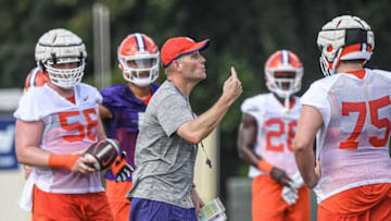 Clemson offensive coordinator Brandon Streeter talks with offensive linemen including offensive lineman Will Putnam (56), left, during the first day of fall football practice at the Allen Reeves Complex in Clemson Friday, August 5, 2022.Clemson Football First Day Fall Practice