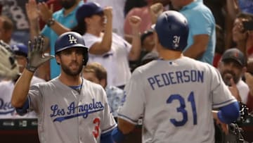 PHOENIX, AZ - AUGUST 09: Chris Taylor #3 of the Los Angeles Dodgers high fives Joc Pederson #31 after Pederson scored against the Arizona Diamondbacks during the seventh inning of the MLB game at Chase Field on August 9, 2017 in Phoenix, Arizona. (Photo by Christian Petersen/Getty Images)