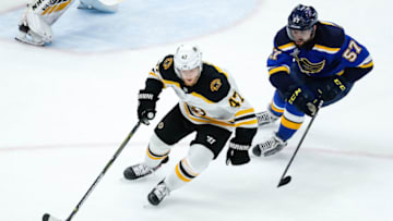 ST. LOUIS, MO - JUNE 09: Boston Bruins' Torey Krug, left, makes a move with the puck while under pressure from St. Louis Blues' David Perron during the first period of Game 6 of the NHL Stanley Cup Finals hockey game between the St. Louis Blues and the Boston Bruins on June 9, 2019, at the Enterprise Center in St. Louis, MO. (Photo by Tim Spyers/Icon Sportswire via Getty Images)