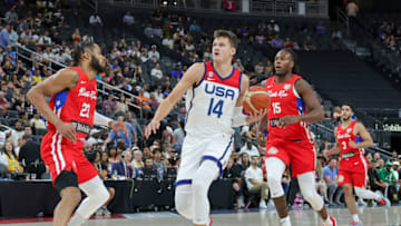 LAS VEGAS, NEVADA - AUGUST 07: Walker Kessler #14 of the United States drives to the basket against Phillip Wheeler #23 and Timajh Parker-Rivera #15 of Puerto Rico in the second half of a 2023 FIBA World Cup exhibition game at T-Mobile Arena on August 07, 2023 in Las Vegas, Nevada. The United States defeated Puerto Rico 117-74. (Photo by Ethan Miller/Getty Images)