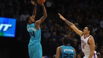 Dec 26, 2014; Oklahoma City, OK, USA; Charlotte Hornets forward Michael Kidd-Gilchrist (14) attempts a shot agaisnt Oklahoma City Thunder center Steven Adams (12) during the third quarter at Chesapeake Energy Arena. Mandatory Credit: Mark D. Smith-USA TODAY Sports