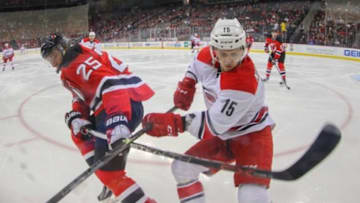 Dec 29, 2015; Newark, NJ, USA; New Jersey Devils center Stefan Matteau (25) and Carolina Hurricanes right wing Andrej Nestrasil (15) battle along the boards during the first period at Prudential Center. Mandatory Credit: Ed Mulholland-USA TODAY Sports