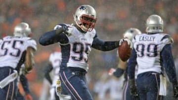 Nov 29, 2015; Denver, CO, USA; New England Patriots defensive end Chandler Jones (95) reacts to his interception in the second quarter against the Denver Broncos at Sports Authority Field at Mile High. Mandatory Credit: Ron Chenoy-USA TODAY Sports