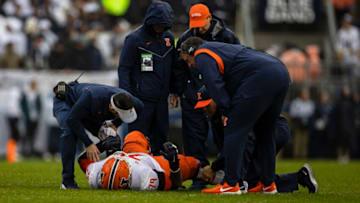 STATE COLLEGE, PA - OCTOBER 23: Vederian Lowe #79 of the Illinois Fighting Illini receives attention from head coach Bret Bielema and the training staff after being injured on a play against the Penn State Nittany Lions during the first half at Beaver Stadium on October 23, 2021 in State College, Pennsylvania. (Photo by Scott Taetsch/Getty Images)