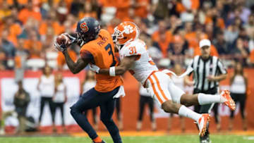 SYRACUSE, NY - OCTOBER 13: Ervin Philips #3 of the Syracuse Orange makes a first down reception during the second quarter as he is tackled by Ryan Carter #31 of the Clemson Tigers at the Carrier Dome on October 13, 2017 in Syracuse, New York. (Photo by Brett Carlsen/Getty Images)