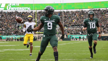 EAST LANSING, MICHIGAN - OCTOBER 30: Kenneth Walker III #9 of the Michigan State Spartans scores a first half touchdown in front of Vincent Gray #4 of the Michigan Wolverines at Spartan Stadium on October 30, 2021 in East Lansing, Michigan. (Photo by Gregory Shamus/Getty Images)