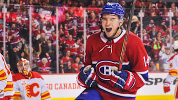 CALGARY, AB - DECEMBER 19: Nick Suzuki #14 of the Montreal Canadiens scores against David Rittich #33 of the Calgary Flames to tie the game and force overtime during an NHL game at Scotiabank Saddledome on December 19, 2019 in Calgary, Alberta, Canada. (Photo by Derek Leung/Getty Images)