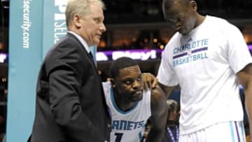 Dec 17, 2014; Charlotte, NC, USA; Charlotte Hornets guard Lance Stephenson (1) is helped up after a fall during the second half of the game against the Phoenix Suns at Time Warner Cable Arena. The Suns win 111-106. Mandatory Credit: Sam Sharpe-USA TODAY Sports