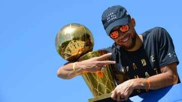 OAKLAND, CA - JUNE 15: Stephen Curry #30 of the Golden State Warriors poses for a photo with the Larry O'Brien Trophy during the Victory Parade and Rally on June 15, 2017 in Oakland, California at The Henry J. Kaiser Convention. NOTE TO USER: User expressly acknowledges and agrees that, by downloading and or using this photograph, User is consenting to the terms and conditions of the Getty Images License Agreement. Mandatory Copyright Notice: Copyright 2017 NBAE (Photo by Noah Graham/NBAE via Getty Images)