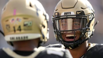 BOULDER, COLORADO - OCTOBER 05: Dimitri Stanley #14 of the Colorado Buffaloes is congratulated by Jaren Mangham #1 after scoring against the Arizona Wildcats in the second quarter at Folsom Field on October 05, 2019 in Boulder, Colorado. (Photo by Matthew Stockman/Getty Images)