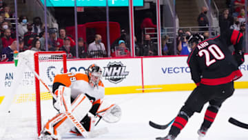 Nov 12, 2021; Raleigh, North Carolina, USA; Carolina Hurricanes center Sebastian Aho (20) comes in on a break away on Philadelphia Flyers goaltender Carter Hart (79) during the second period at PNC Arena. Mandatory Credit: James Guillory-USA TODAY Sports
