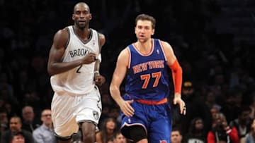 Dec 5, 2013; Brooklyn, NY, USA; New York Knicks power forward Andrea Bargnani (77) has words with Brooklyn Nets power forward Kevin Garnett (2) as they run up the court after Bargnani hits a three-point basket during the fourth quarter of a game at Barclays Center. Bargnani was immediately issues a second technical foul and ejected from the game. Mandatory Credit: Brad Penner-USA TODAY Sports