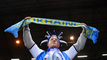 PETERBOROUGH, ENGLAND - MARCH 01: A Peterborough United fan holds a Ukrainian scarf to indicate peace and sympathy with Ukraine prior to the Emirates FA Cup Fifth Round match between Peterborough United and Manchester City at ABAX Stadium on March 01, 2022 in Peterborough, England. (Photo by Laurence Griffiths/Getty Images)