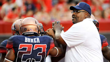 Aug 30, 2013; Tucson, AZ, USA; Arizona Wildcats associate head coach Calvin Magee and running back Jared Baker (23) huddle up before the first quarter against the Northern Arizona Lumberjacks at Arizona Stadium. Arizona beat Northern Arizona 35-0. Mandatory Credit: Casey Sapio-USA TODAY Sports