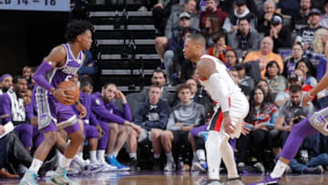 SACRAMENTO, CA - JANUARY 14: De'Aaron Fox #5 of the Sacramento Kings handles the ball against Damian Lillard #0 of the Portland Trail Blazers on January 14, 2019 at Golden 1 Center in Sacramento, California. NOTE TO USER: User expressly acknowledges and agrees that, by downloading and or using this photograph, User is consenting to the terms and conditions of the Getty Images Agreement. Mandatory Copyright Notice: Copyright 2019 NBAE (Photo by Rocky Widner/NBAE via Getty Images)