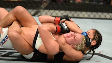 LAS VEGAS, NV - MARCH 04: Cynthia Calvillo (black) attempts to submit Amanda Cooper in their women's strawweight bout during the UFC 209 event at T-Mobile Arena on March 4, 2017 in Las Vegas, Nevada. (Photo by Josh Hedges/Zuffa LLC/Zuffa LLC via Getty Images)