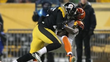 Dec 15, 2013; Pittsburgh, PA, USA; Pittsburgh Steelers running back Felix Jones (23) runs over Cincinnati Bengals cornerback Adam Jones (24) during the second quarter at Heinz Field. Mandatory Credit: Jason Bridge-USA TODAY Sports
