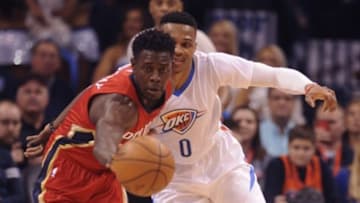 Feb 11, 2016; Oklahoma City, OK, USA; New Orleans Pelicans guard Jrue Holiday (11) steals the ball from Oklahoma City Thunder guard Russell Westbrook (0) during the first quarter at Chesapeake Energy Arena. Mandatory Credit: Mark D. Smith-USA TODAY Sports