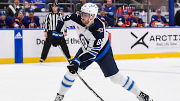Feb 22, 2023; Elmont, New York, USA; Winnipeg Jets left wing Pierre-Luc Dubois (80) attempts a shot against the New York Islanders during the third period at UBS Arena. Mandatory Credit: Dennis Schneidler-USA TODAY Sports