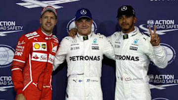 ABU DHABI, UNITED ARAB EMIRATES - NOVEMBER 25: Top three qualifiers Valtteri Bottas of Finland and Mercedes GP, Lewis Hamilton of Great Britain and Mercedes GP and Sebastian Vettel of Germany and Ferrari pose for a photo in parc ferme during qualifying for the Abu Dhabi Formula One Grand Prix at Yas Marina Circuit on November 25, 2017 in Abu Dhabi, United Arab Emirates. (Photo by Mark Thompson/Getty Images)