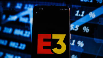 POLAND - 2021/06/15: In this photo illustration an E3 logo displayed on a smartphone with stock market percentages on the background. (Photo Illustration by Omar Marques/SOPA Images/LightRocket via Getty Images)