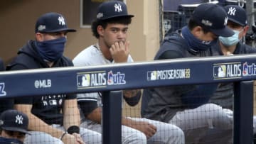 SAN DIEGO, CALIFORNIA - OCTOBER 06: Deivi Garcia #83 of the New York Yankees looks on from the dugout against the Tampa Bay Rays during the second inning in Game Two of the American League Division Series at PETCO Park on October 06, 2020 in San Diego, California. (Photo by Christian Petersen/Getty Images)