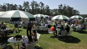 Apr 13, 2014; Augusta, GA, USA; A general view of patrons sitting at tables under umbrellas near the clubhouse and first tee during the final round of the 2014 The Masters golf tournament at Augusta National Golf Club. Mandatory Credit: Michael Madrid-USA TODAY Sports