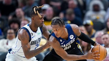 INDIANAPOLIS, INDIANA - MARCH 27: Bennedict Mathurin #00 of the Indiana Pacers dribbles the ball while being guarded by Reggie Bullock #25 of the Dallas Mavericks in the third quarter at Gainbridge Fieldhouse on March 27, 2023 in Indianapolis, Indiana. NOTE TO USER: User expressly acknowledges and agrees that, by downloading and or using this photograph, User is consenting to the terms and conditions of the Getty Images License Agreement. (Photo by Dylan Buell/Getty Images)