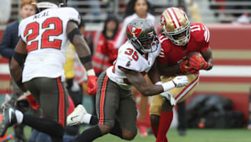 SANTA CLARA, CALIFORNIA - DECEMBER 11: Brandon Aiyuk #11 of the San Francisco 49ers catches a pass for a touchdown against Jamel Dean #35 of the Tampa Bay Buccaneers during the first half of the game at Levi's Stadium on December 11, 2022 in Santa Clara, California. (Photo by Lachlan Cunningham/Getty Images)
