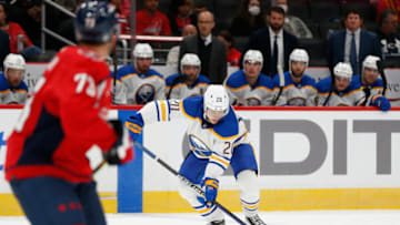 Sep 25, 2022; Washington, District of Columbia, USA; Buffalo Sabres defenseman Lawrence Pilut (20) controls the puck in front of Washington Capitals left wing Conor Sheary (73) during the second period at Capital One Arena. Mandatory Credit: Amber Searls-USA TODAY Sports